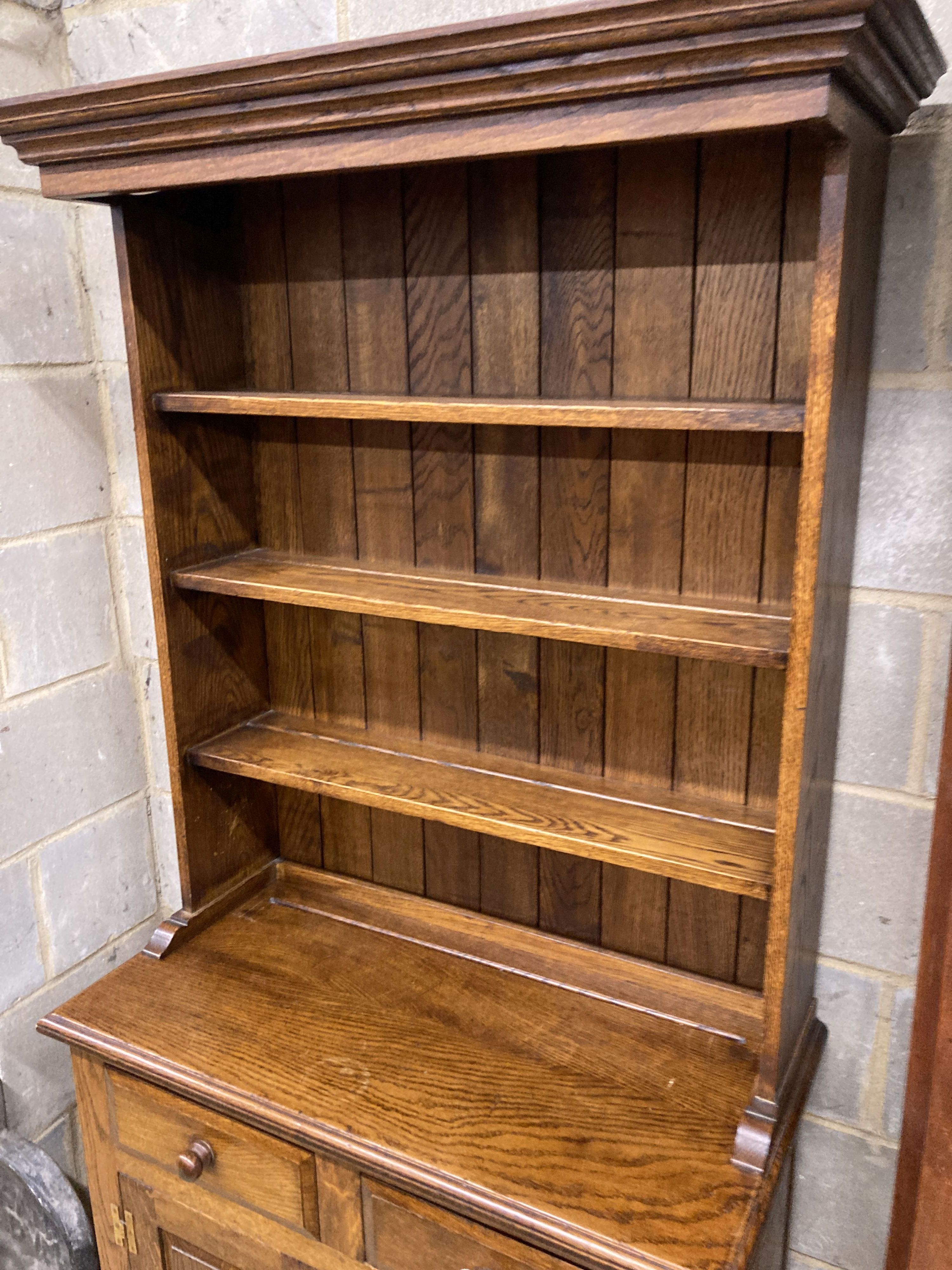 A small 18th century style narrow oak dresser, length 86cm, depth 43cm, height 187cm